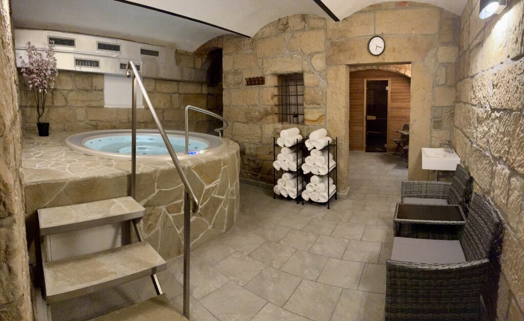 Private wellness at Resort Mezná with a jacuzzi, sauna, and relaxation area in a natural stone design